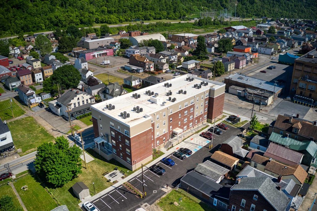 arial view of a brick building with a white roof