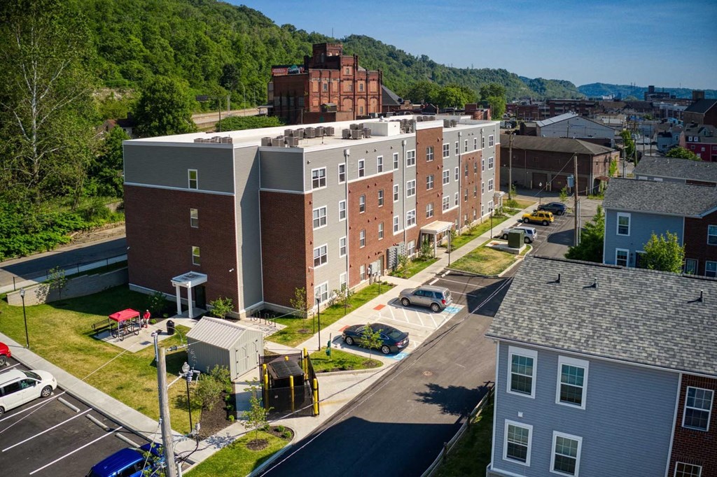 an aerial view of an apartment complex with a mountain in the background
