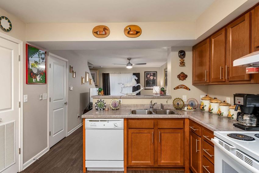 a kitchen with white appliances and wooden cabinets - Photo Gallery
