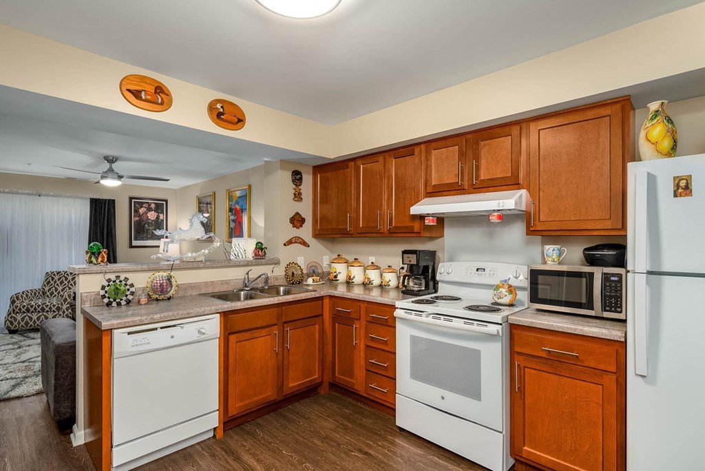 a kitchen with white appliances and wooden cabinets