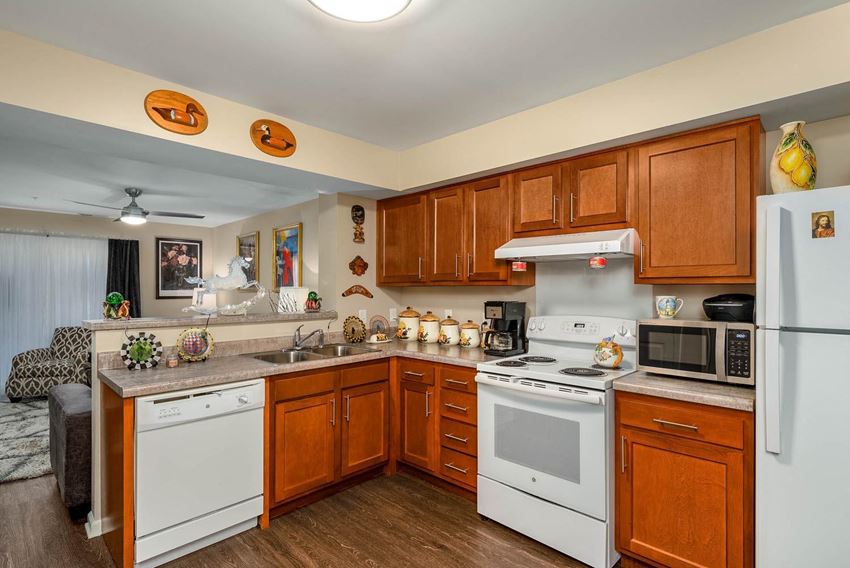a kitchen with white appliances and wooden cabinets - Photo Gallery