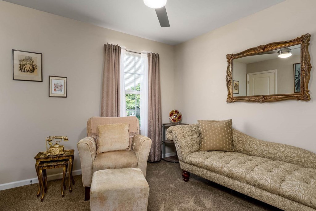a living room with a couch and two chairs