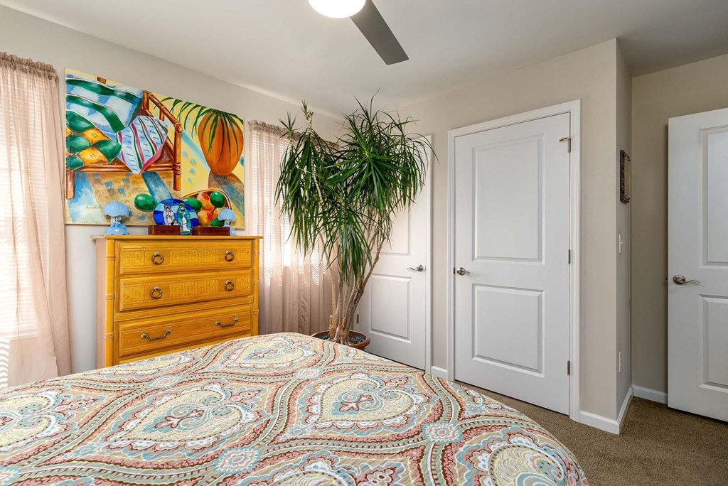 a bedroom with a bed and a dresser