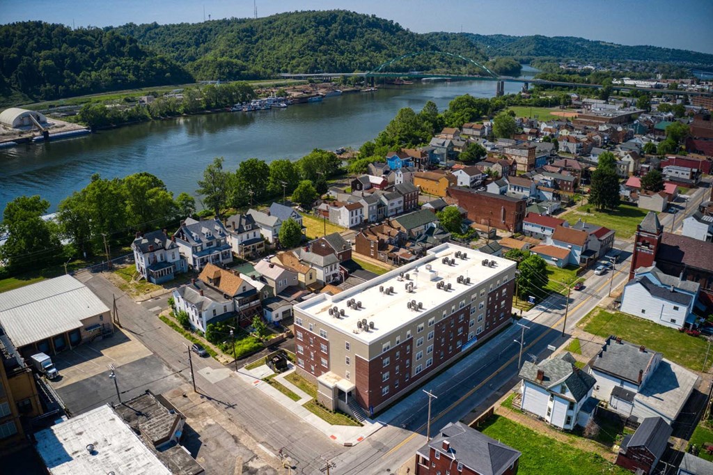 an aerial view of a small town with a river in the background