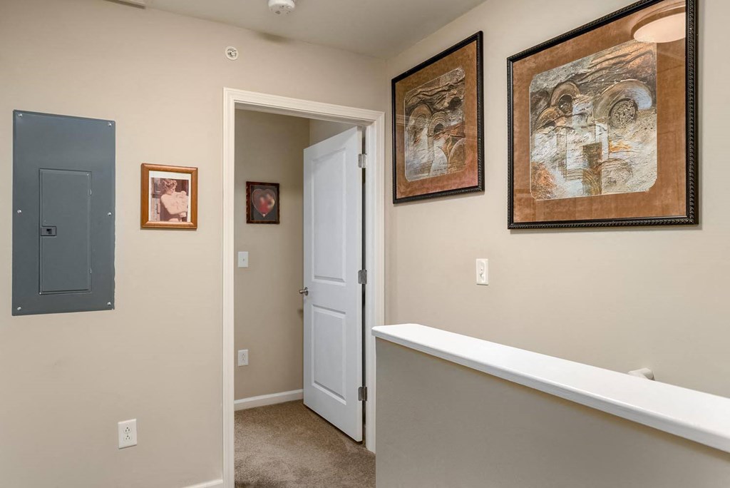 a hallway with pictures on the wall
