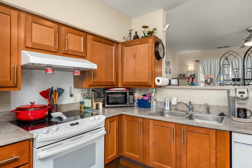 a kitchen with a stove top oven next to a sink
