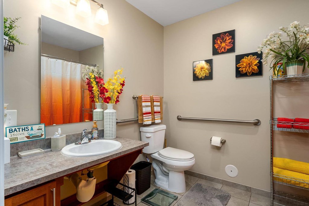 a bathroom with a toilet sink and mirror