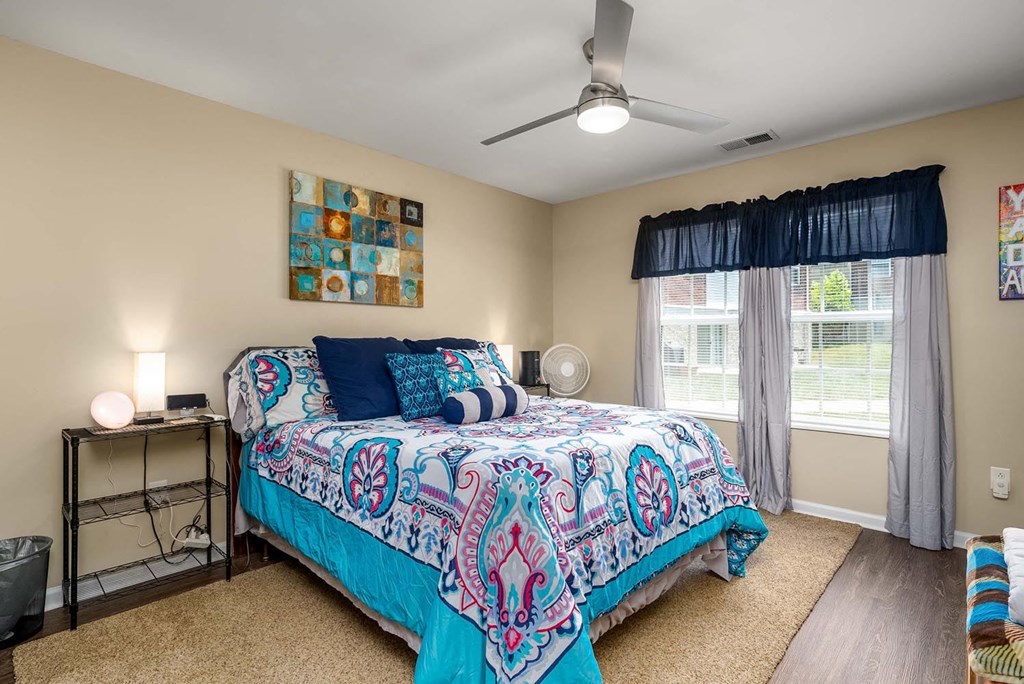 a bedroom with a bed and a window