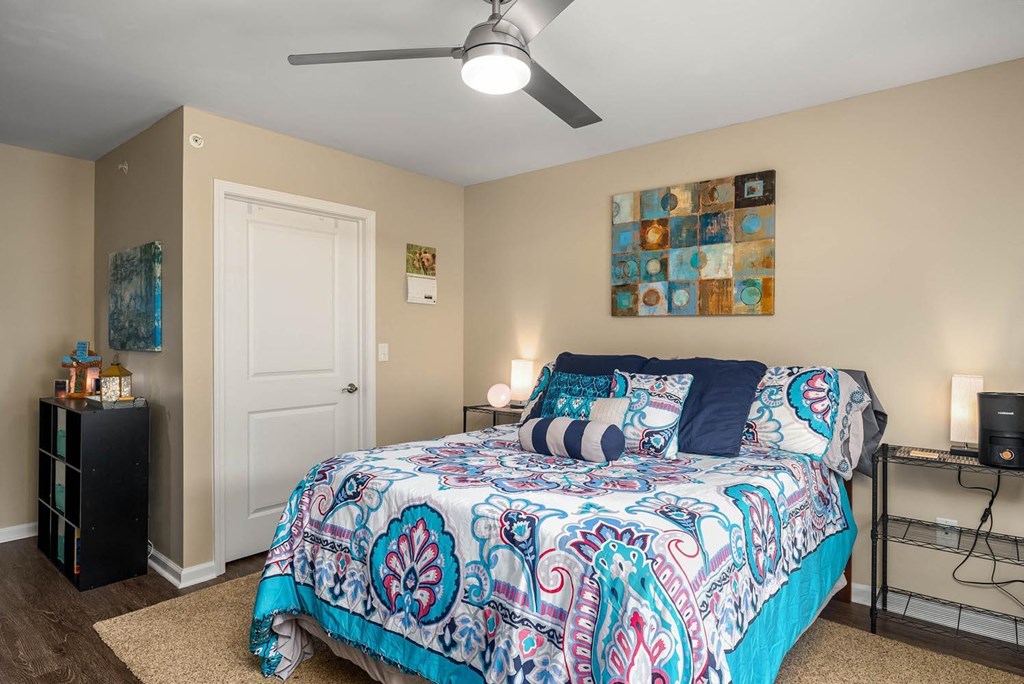 a bedroom with a bed and a ceiling fan