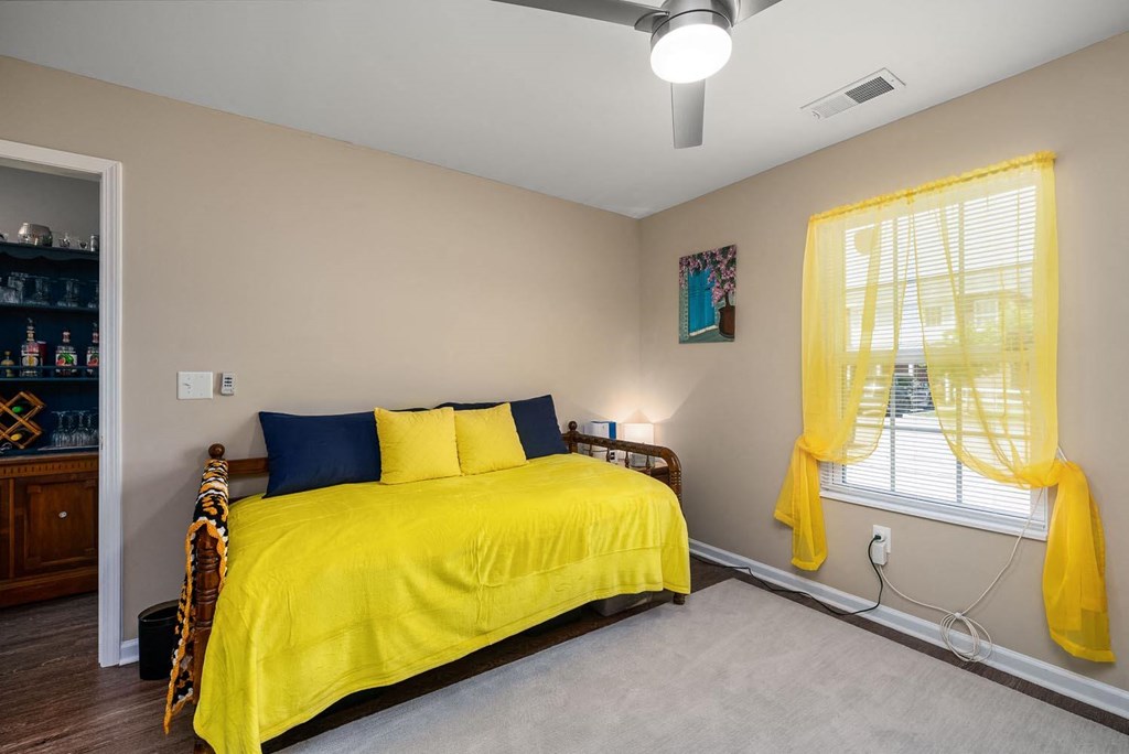 a bedroom with a bed and a window