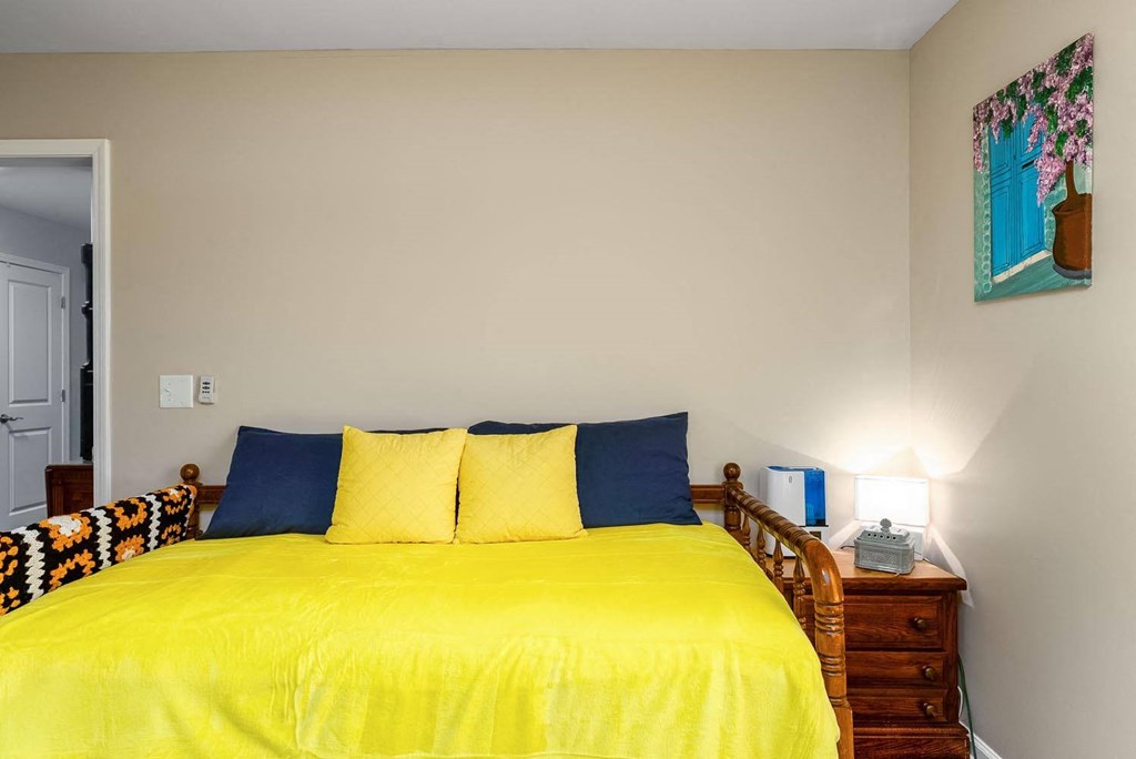 a bedroom with a bed and a nightstand