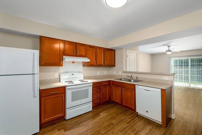 a kitchen with wooden cabinets and white appliances