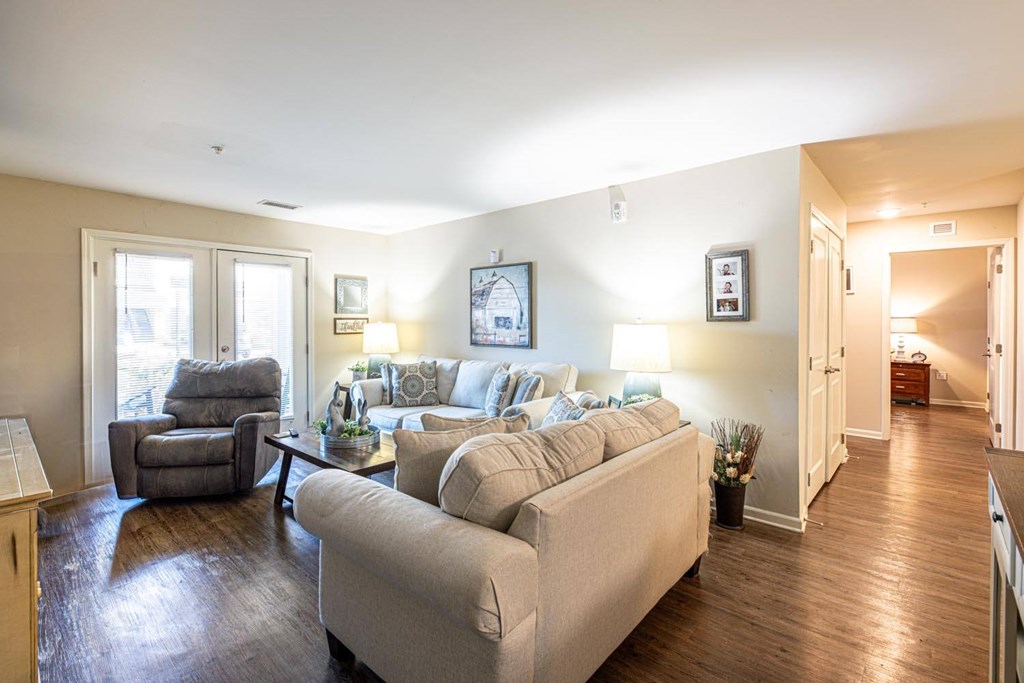 A living room with a couch, chair, and coffee table.
