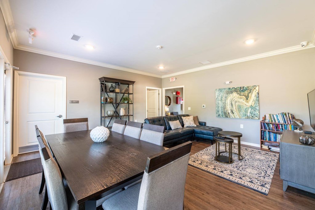A dining room with a wooden table and chairs.