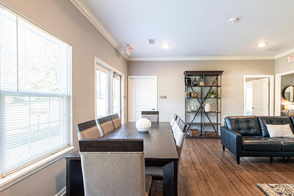 A modern dining room with a dark wood table and chairs.