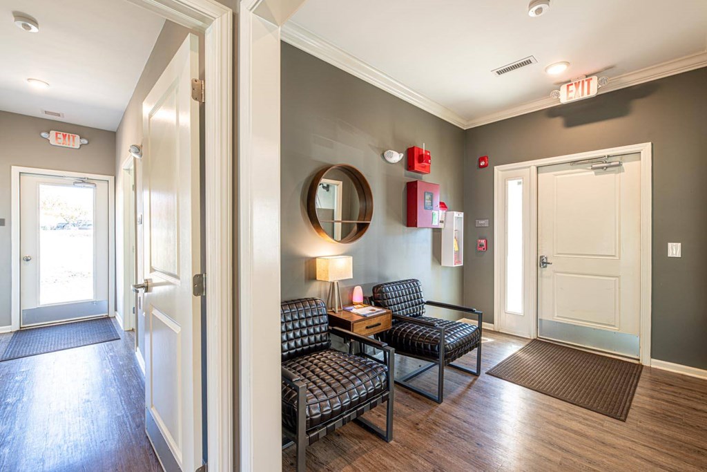 A hallway with a couch and a mirror on the wall.