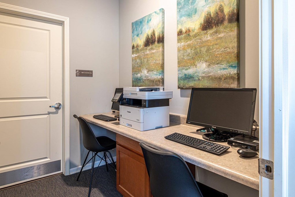A white desk with a computer monitor, keyboard, and mouse.