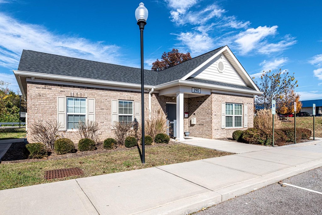 A small building with a black lamp post in front of it.