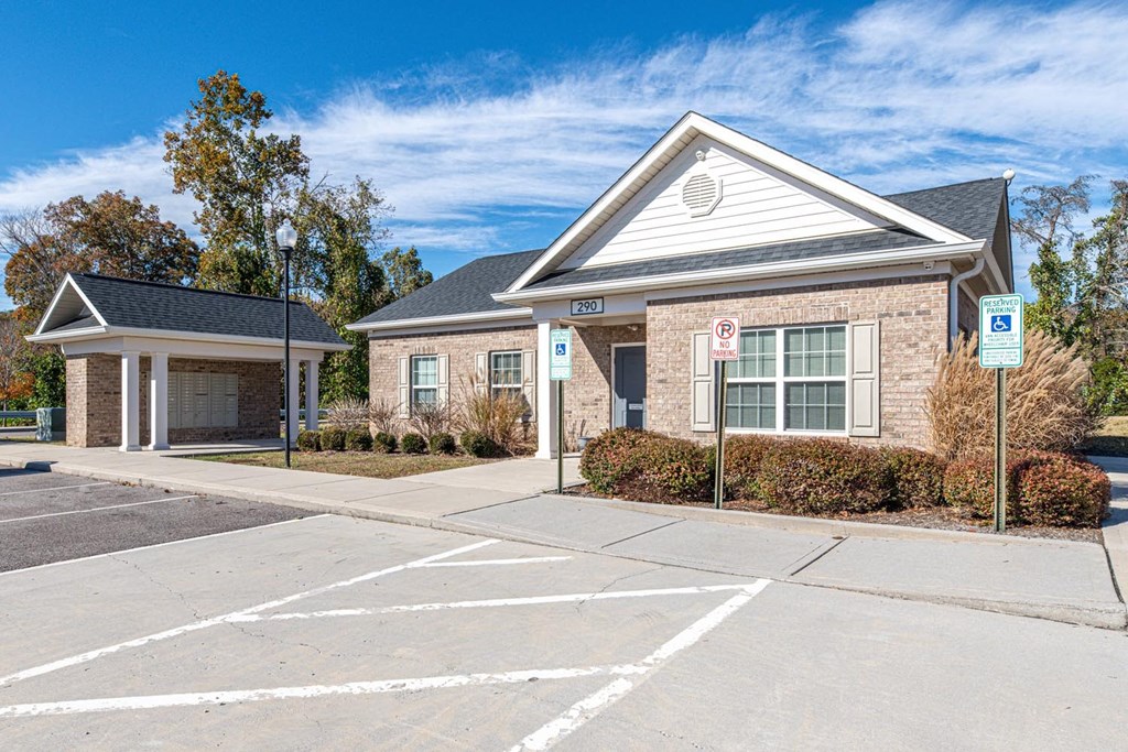 A building with a parking lot in front of it.