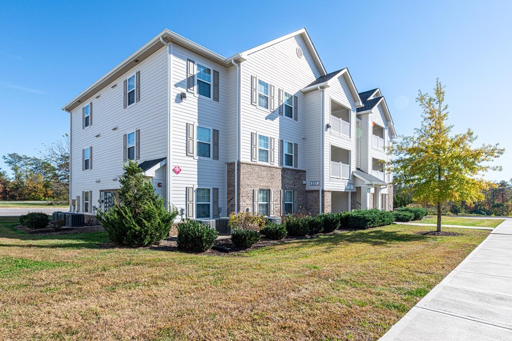 A large white apartment building with a red heart on the front.