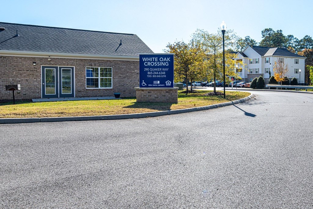 A sign in front of a building that says White Oak Crossing.