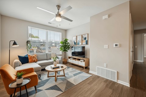 A living room with a brown chair and a blue rug.
