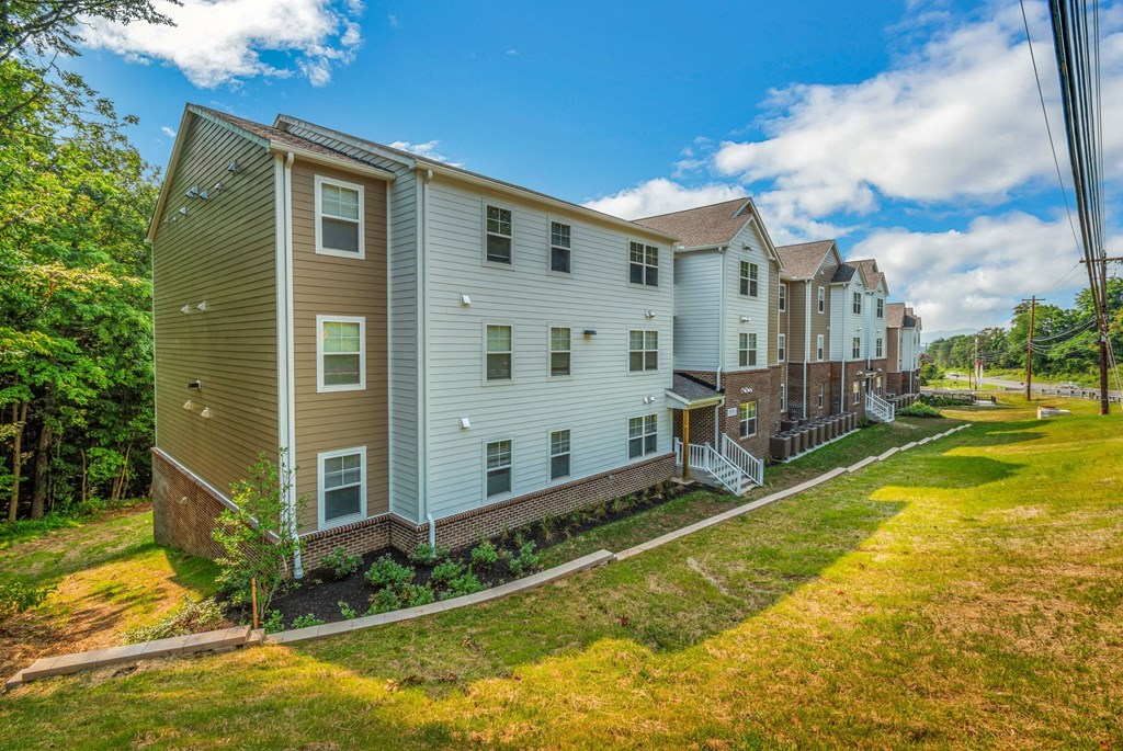 a row of apartment buildings on the side of a street