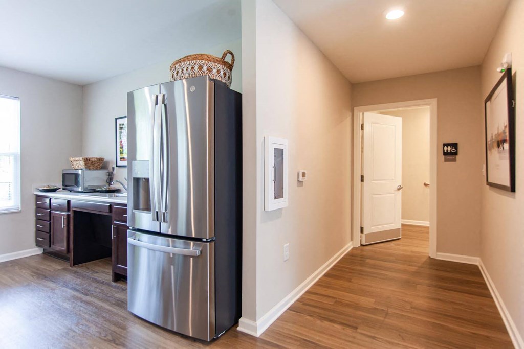 a kitchen with a stainless steel refrigerator