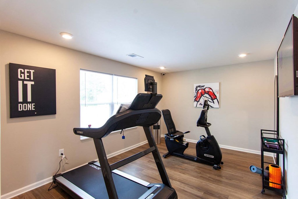 a home gym with a treadmill and exercise equipment