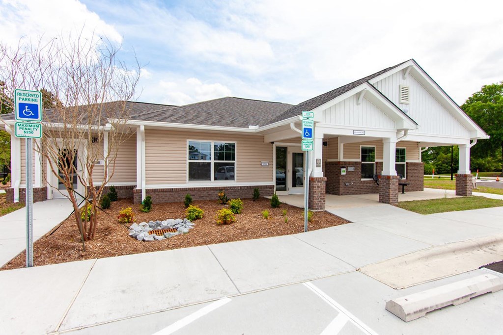 the front of a house with a porch and a driveway