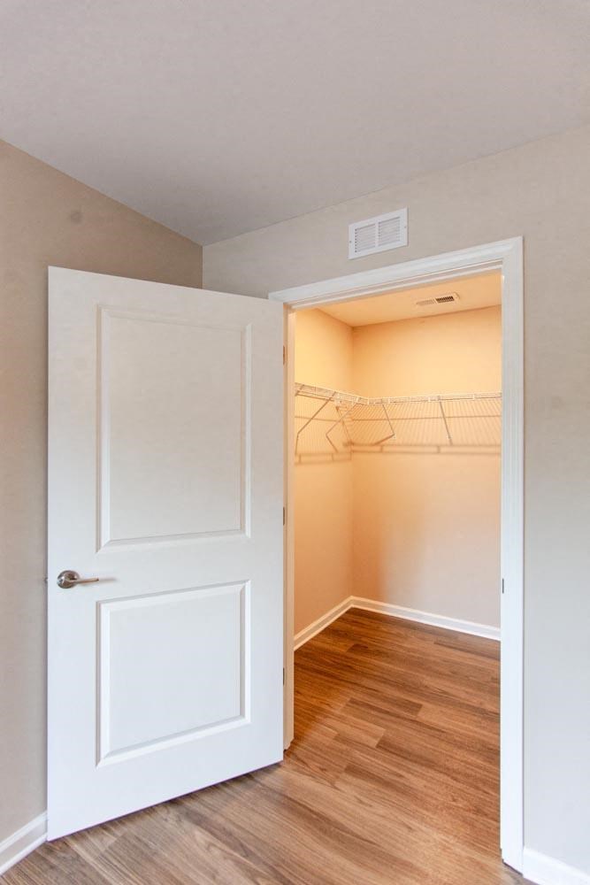 an empty room with a closet and a white door