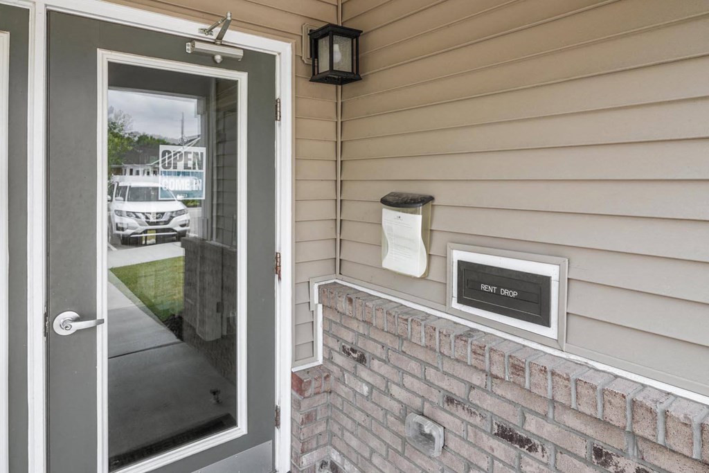 the front door of a home with a mailbox on the wall