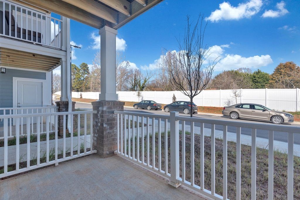 a porch with cars parked in a parking lot