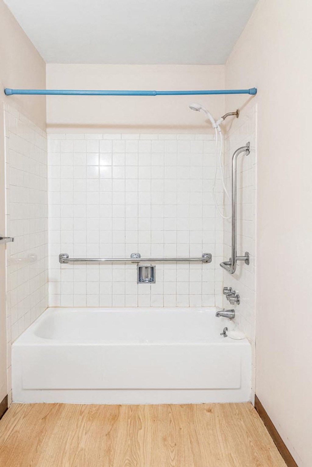 a white bath tub sitting next to a shower