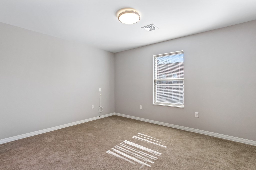 an empty room with a window and the word rent on the floor