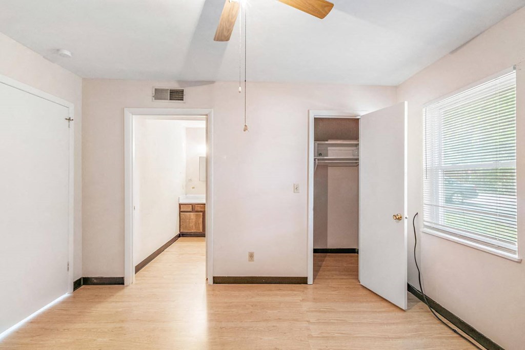 a bedroom with a medium sized bed and a ceiling fan