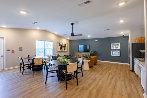 A dining room with a wooden table and chairs.