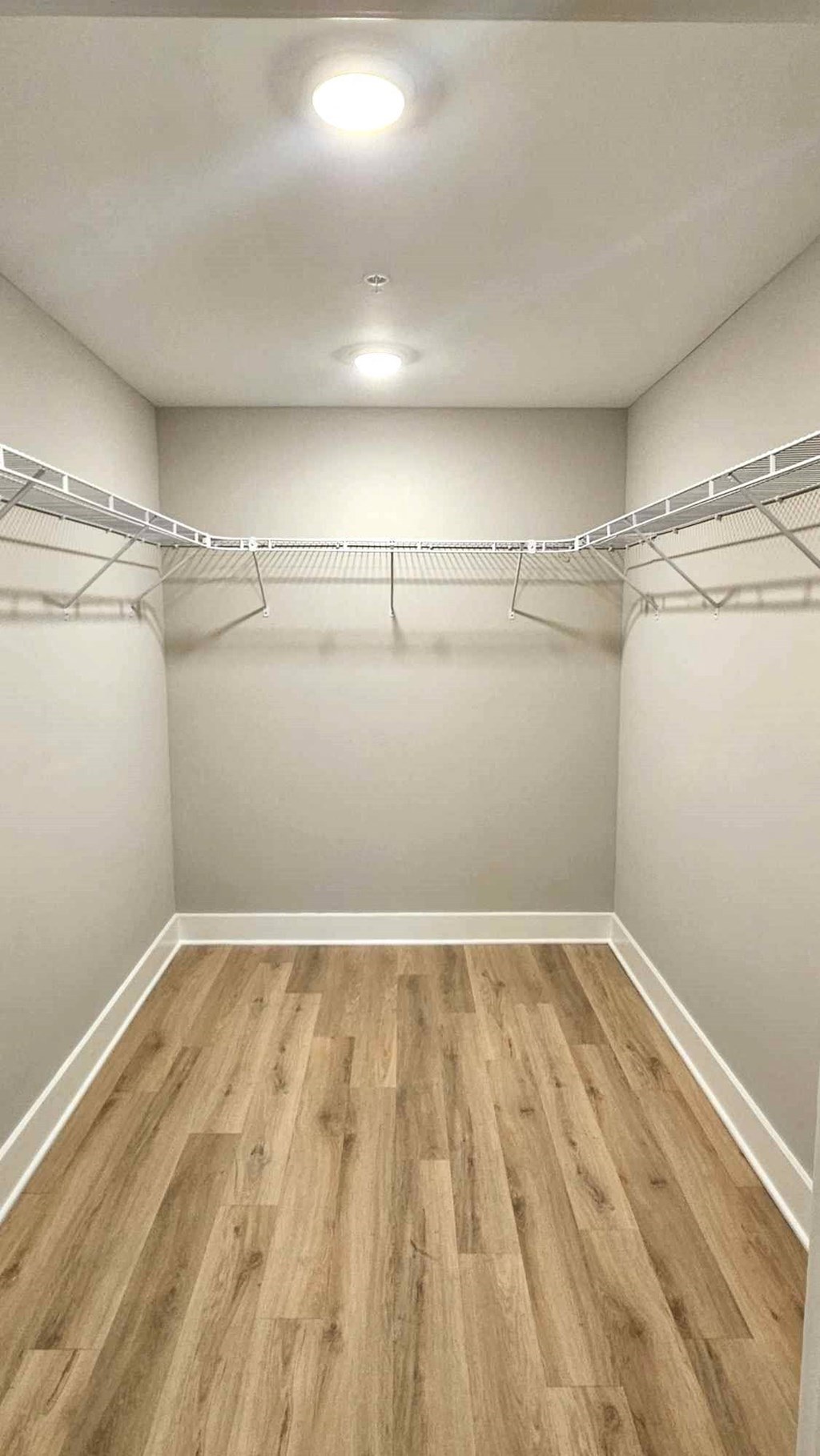 an empty room with a closet and a wooden floor