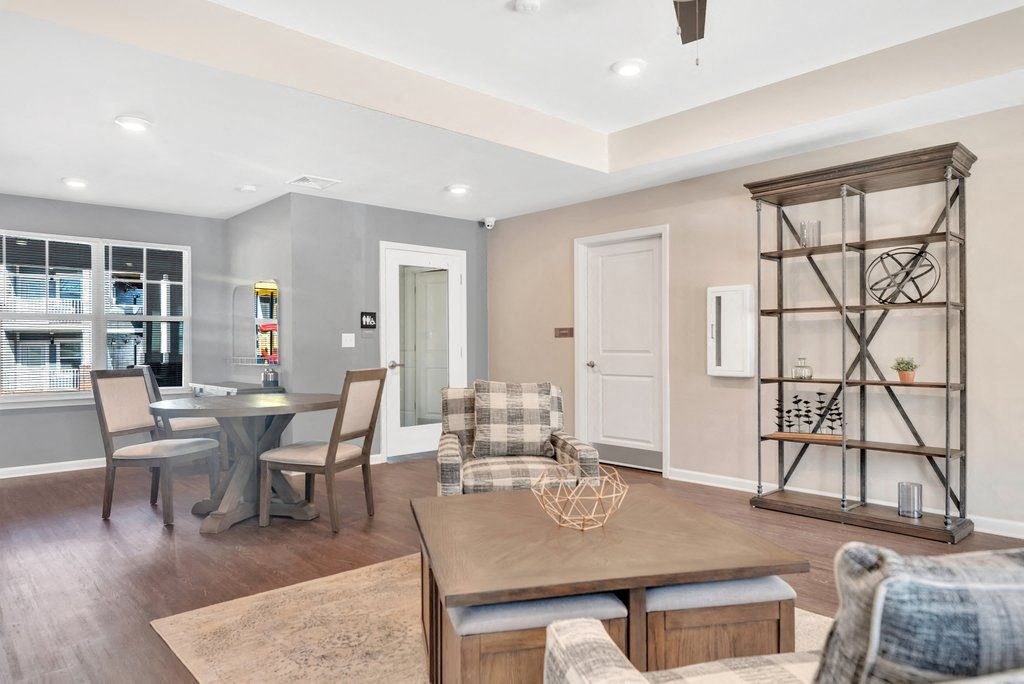 a living room and dining room with a table and chairs