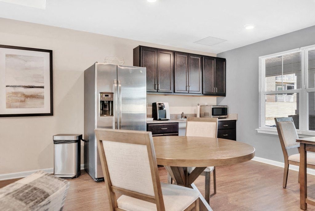 a kitchen and dining room with a table and chairs