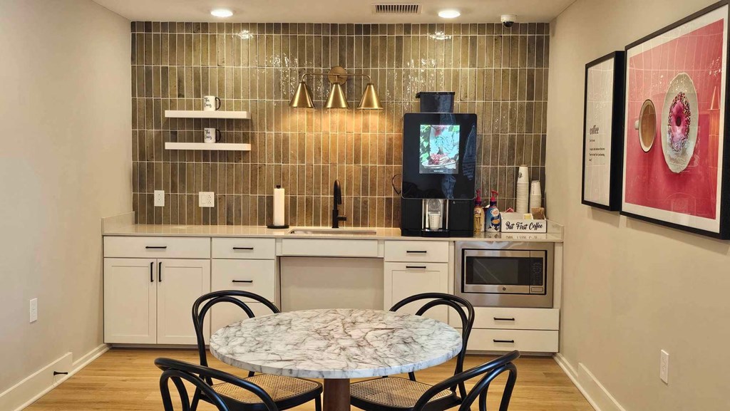 a small kitchen with a table and chairs and a tv