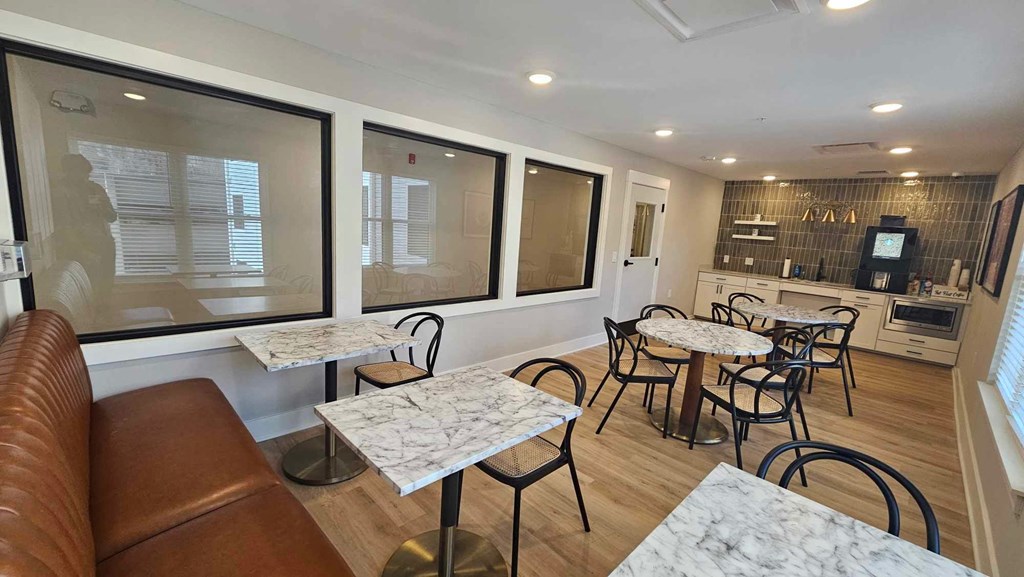 a seating area with tables and chairs in a restaurant