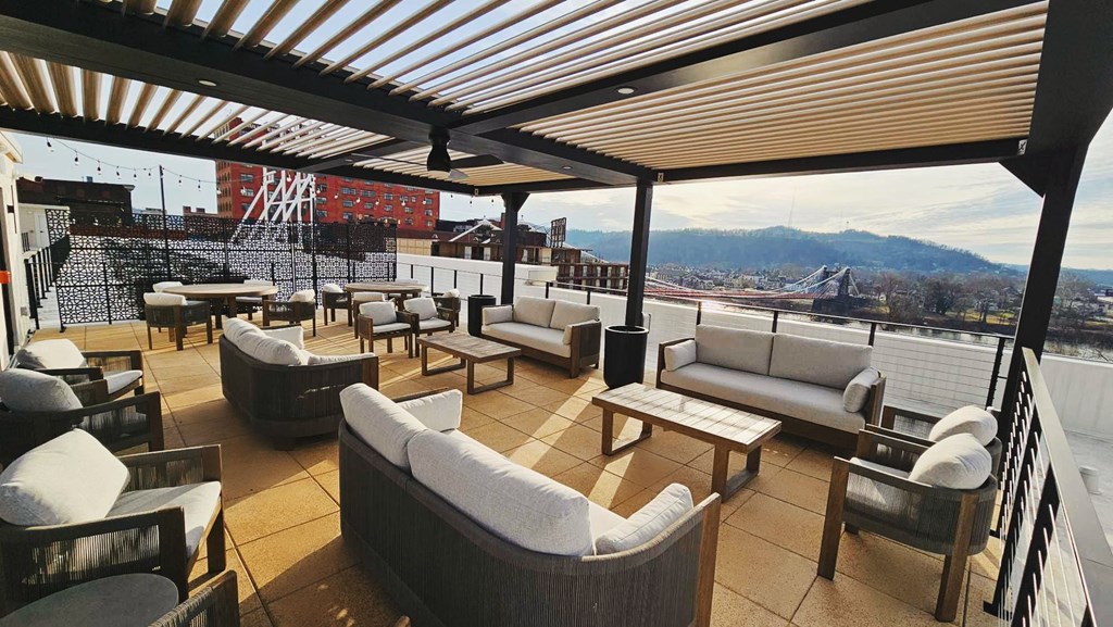 a terrace with couches and tables on a roof top