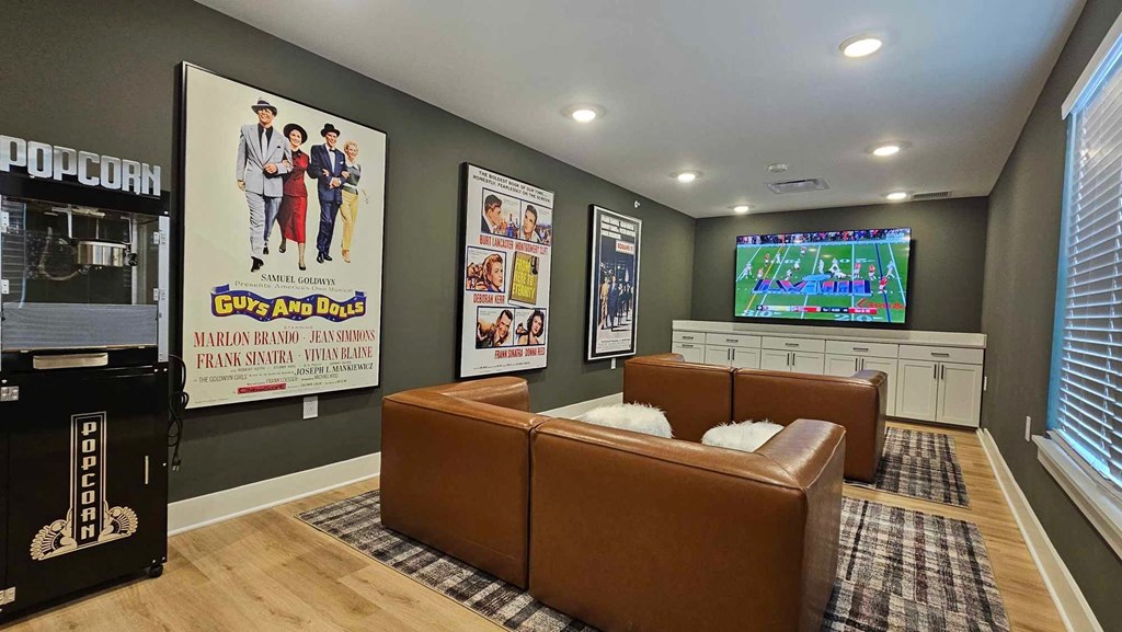 a living room with leather couches and a tv