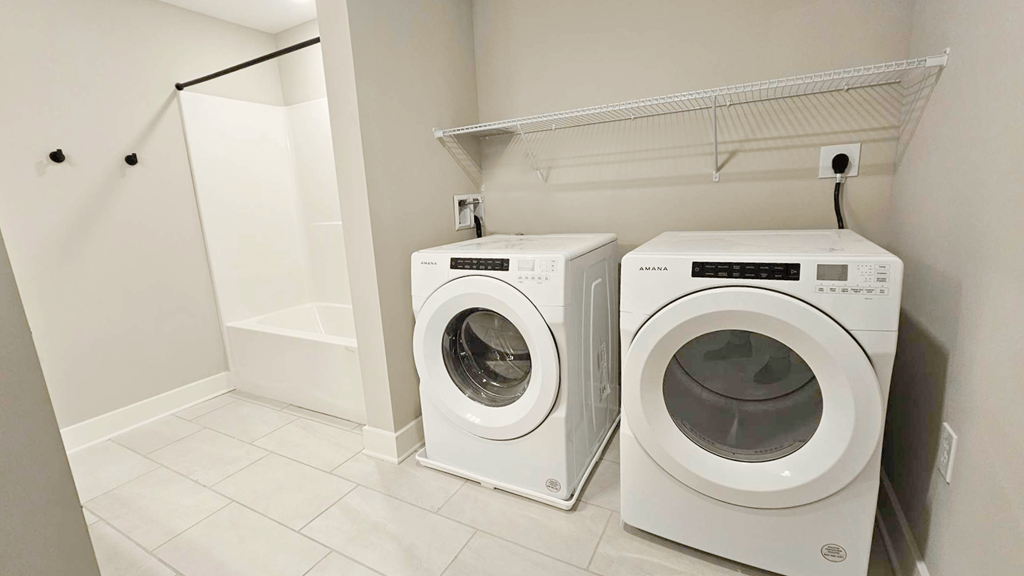 a washing machine and a dryer in a laundry room