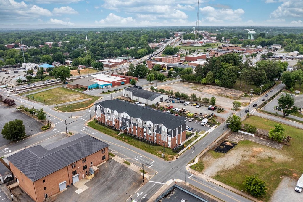 an aerial view of an apartment complex with a city in the background