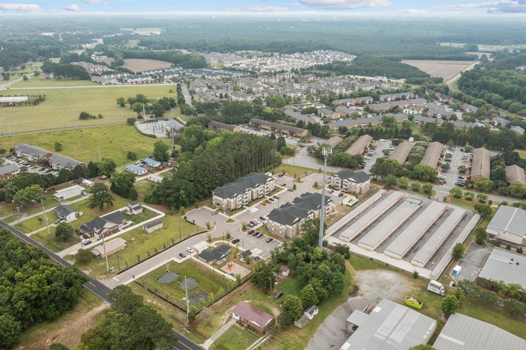an aerial view of a city with rooftops of buildings and trees