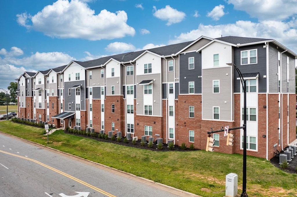 a photo of a row of apartment buildings on a sunny day