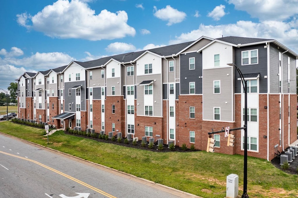 a photo of a row of apartment buildings on a sunny day