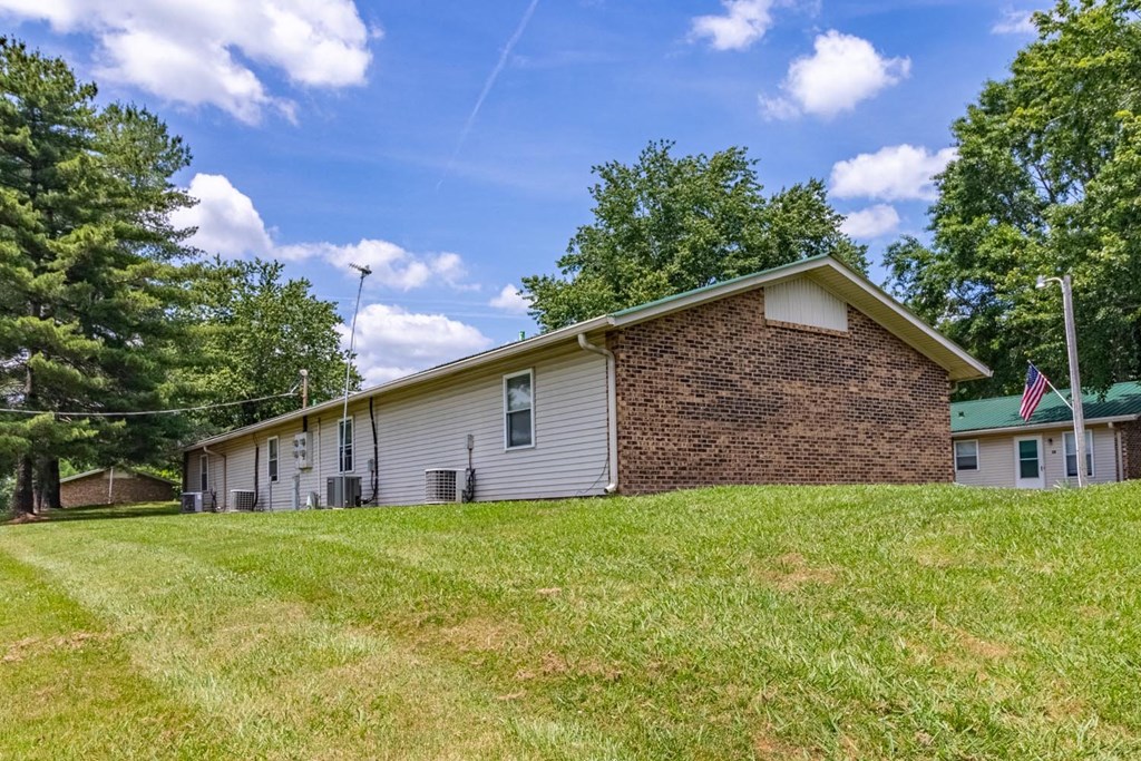 a house on a hill with a blue sky in the background